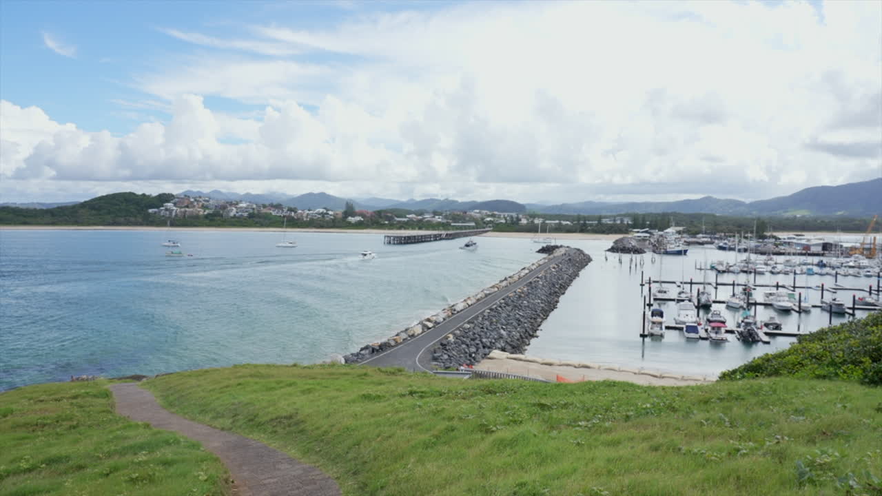 Wide shot of a fishing boat arrives back to the marina at Coffs Harbour, New South Wales Australia