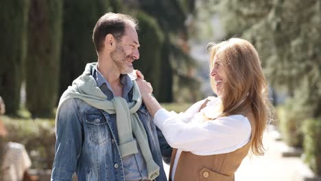 happy mature couple hugging in city park