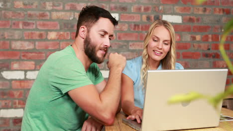 Photo-editors-working-at-desk-using-laptop