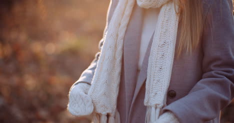 woman putting wool gloves on hands in winter 1