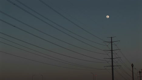 Mediumshot-Of-The-Moon-High-Above-Powerline