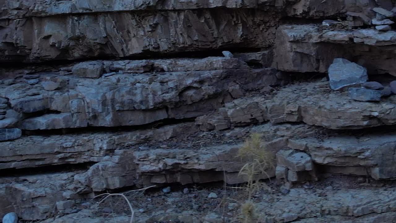 Exploring rocky terrain in Greece with stacked stones at sunset