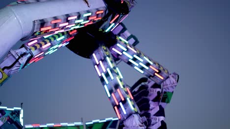 illuminated ride spinning against evening sky