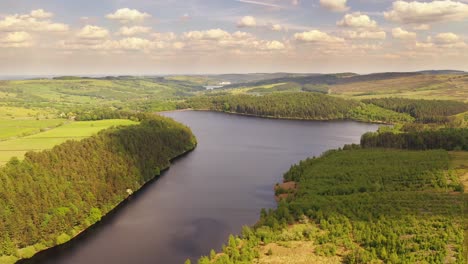 incredible aerial shot over a snaking river and rolling hills in britain