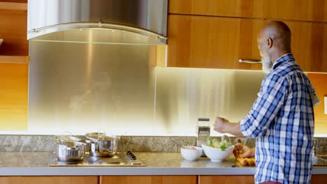 senior man preparing vegetable in kitchen 4k