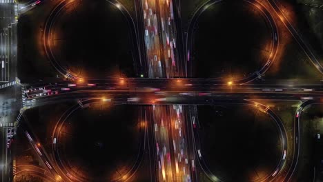 timelapse of traffic at cloverleaf interchange, butterfly-shaped road intersection at night