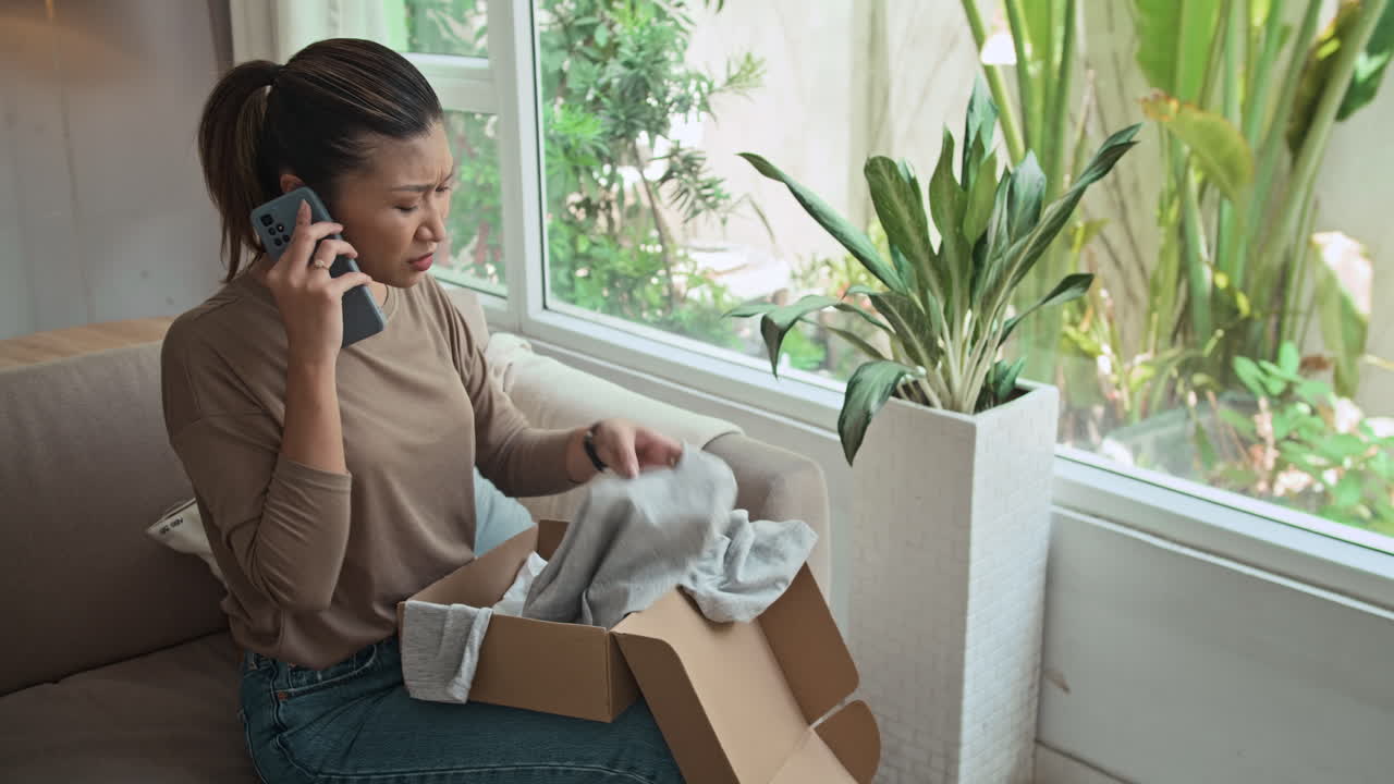 Asian Woman Talking to Customer Service about Problem with Her Parcel