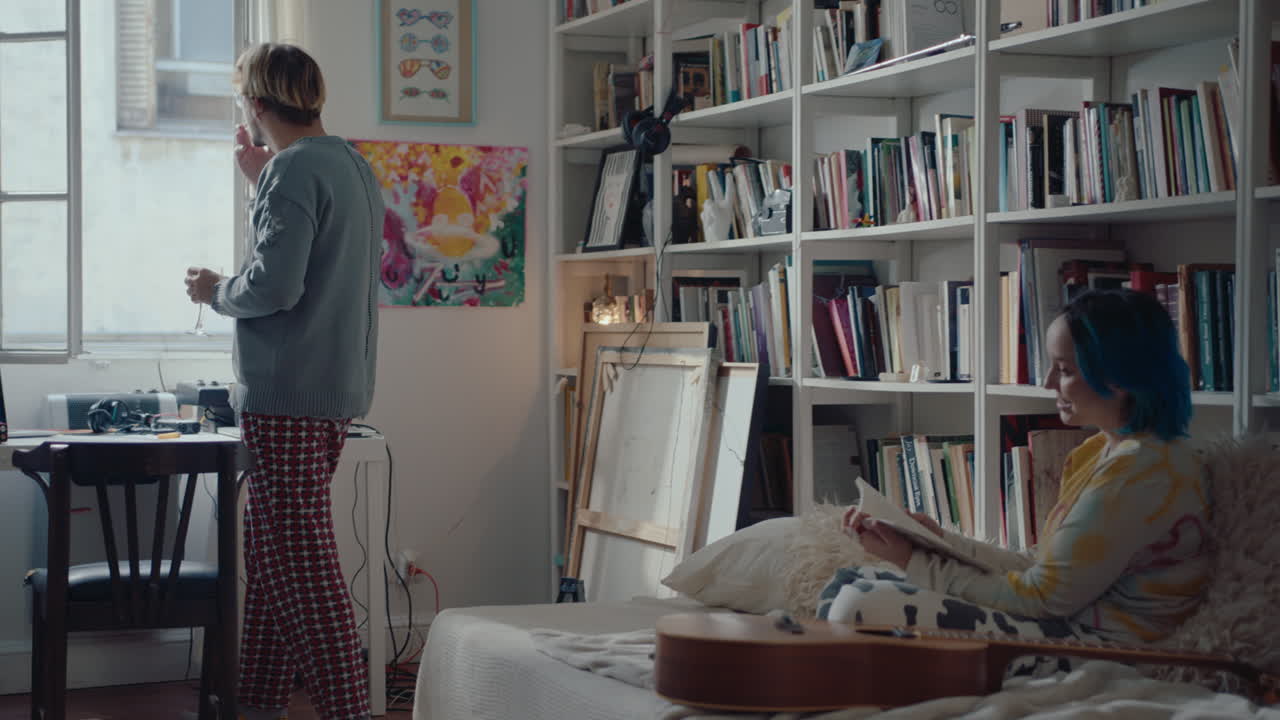 Man Speaking with Girlfriend before Recording Music at Home