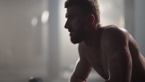 Beautiful-Athletic-man-Wipes-Sweat-from-His-Forehead-with-a-Hand-Looks-into-Camera.-He's-Tired-after-Intensive-Cross-Fitness-Exercise