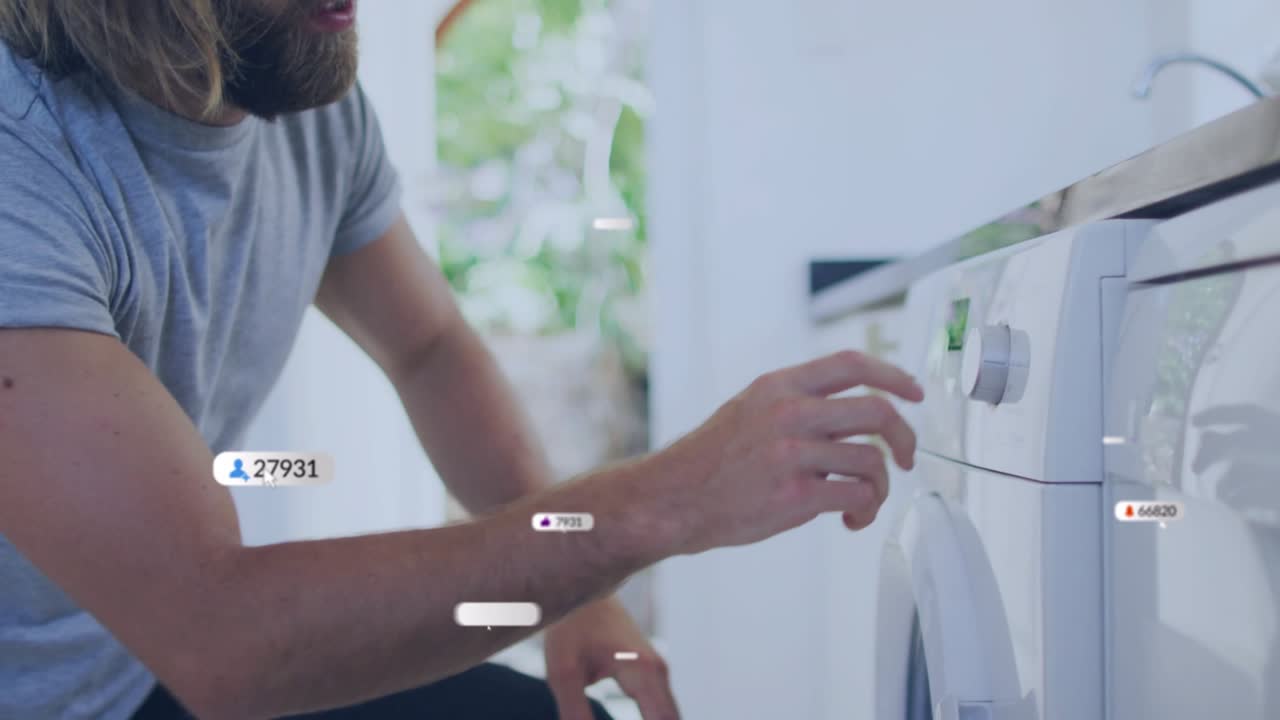 Appliance user kneeling at washer, loading laundry causing UI notifications initiating wash cycle