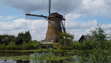 windmills, netherlands: lateral camera movement to a fantastic windmill and that is in a small river