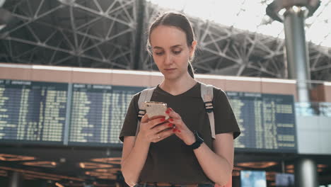 a young woman is online check-in to board the plane. booking a car through the smartphone app. car sharing services from your smartphone. hotel reservation via phone