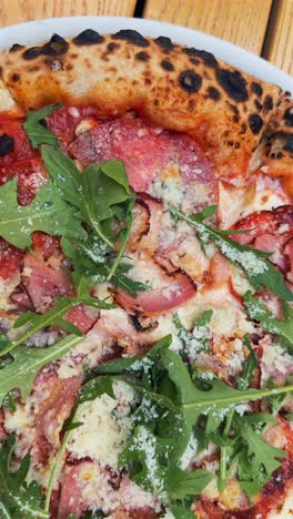 delicious pizza with arugula and ham