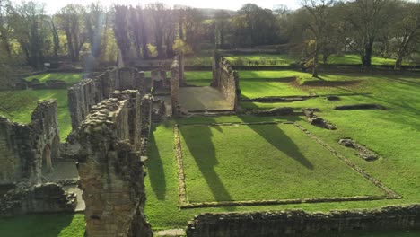 Basingwerk-abbey-landmark-medieval-abandoned-Welsh-ruins-Aerial-view-close-pull-back-right