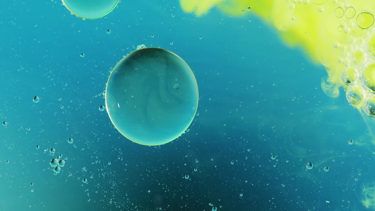 Animation of bubbles and green liquid moving on blue background with copy space