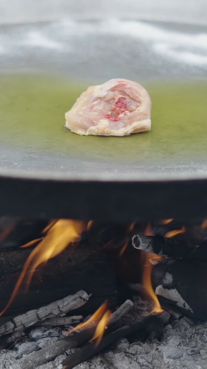 Cooking chicken over an open fire