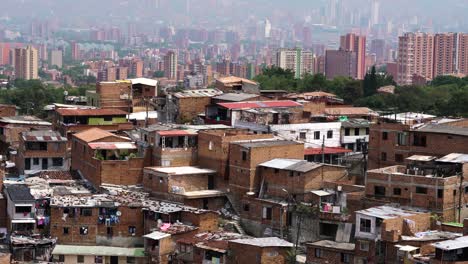 shanty town in medellin, colombia with skyline in background