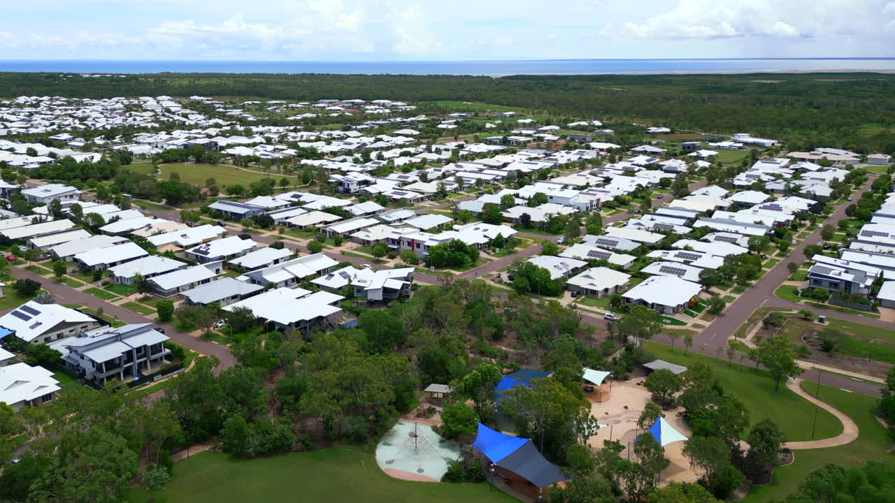 오스트레일리아의 무어헤드, 다윈, 앤타이에서 하 지붕과 태양 전지판을 가진 주거 공원 타운하우스 에스테이트의 공중 드론
