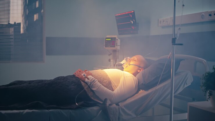 Patient in hospital bed with medical equipment