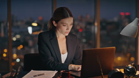 Corporate professional working night finishing project in deadline at workplace.