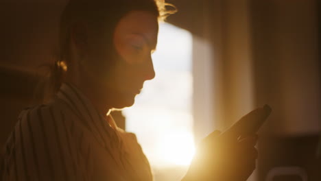 Silhouette-of-Woman-Browsing-Social-Media-in-Sunlight