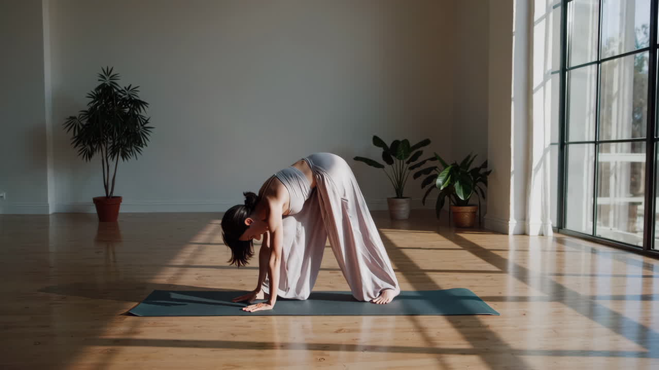Woman practicing yoga in a sunny studio