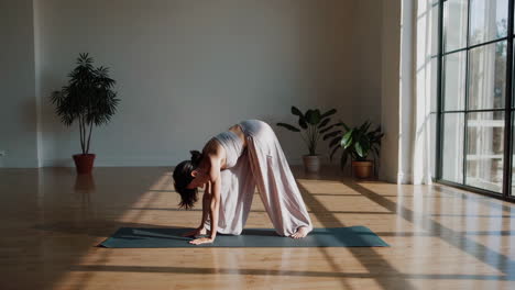 woman practicing yoga in a sunny studio