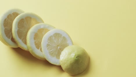 Video-of-sliced-lemon-with-copy-space-over-yellow-background