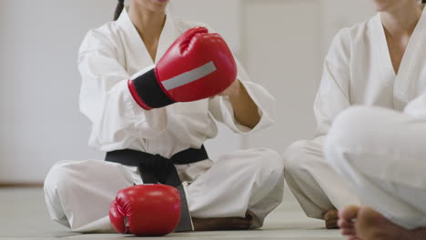 woman putting fighting gloves on