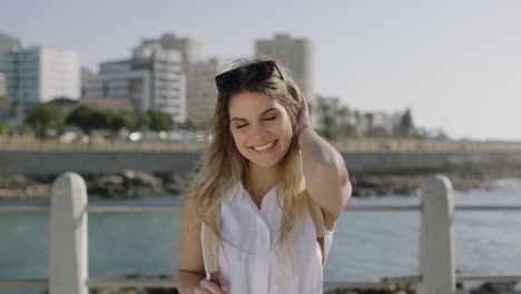 portrait of beautiful young woman laughing cheerful flirty looking to camera enjoying sunny beachfront