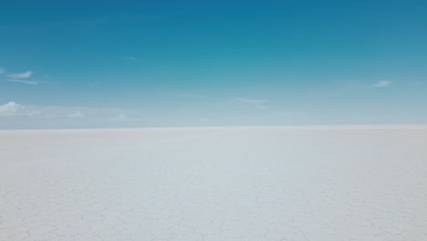 experience the awe-inspiring natural beauty of bolivia's salar de uyuni in the daylight with mesmerizing drone footage showcasing the vast expanse of the endless salt flats from above