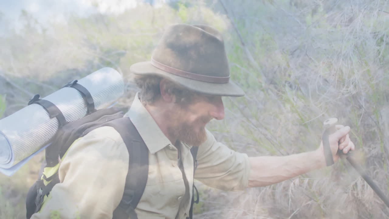 man hiking through dry brush using trekking pole, showing animated elevation graph and tech icons