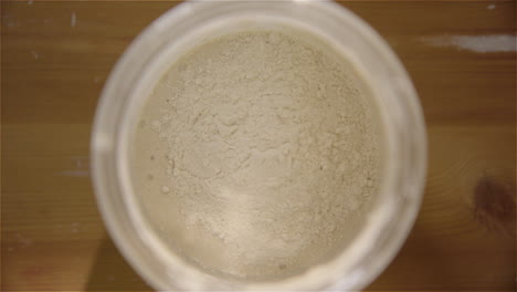 top down - sourdough starter is fed with flour and water