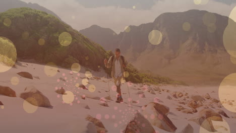 animation of light spots over disabled biracial man walking in mountains