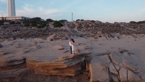 Loving-bride-and-groom-on-seashore-at-sunset