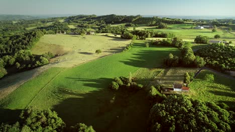 aerial view of rolling hills and straw bales.