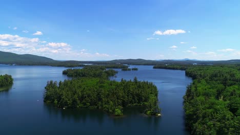 Drone-footage-of-a-serene-lake-in-NH-surrounded-by-green-trees