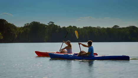 two people kayaking on a calm lake