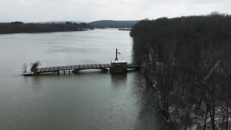 lake sequoyah old bridge on a winter snowy day, aerial drone shot, forward