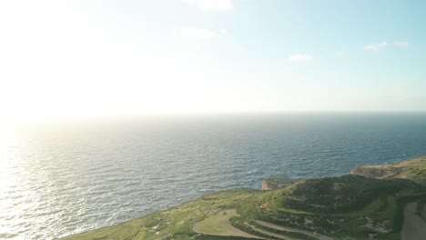 AERIAL:-Flying-Very-High-Above-Greenery-Hills-in-Malta