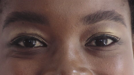 close-up-african-american-woman-eyes-wearing-makeup-looking-happy-at-camera-blinking-beauty-cosmetics