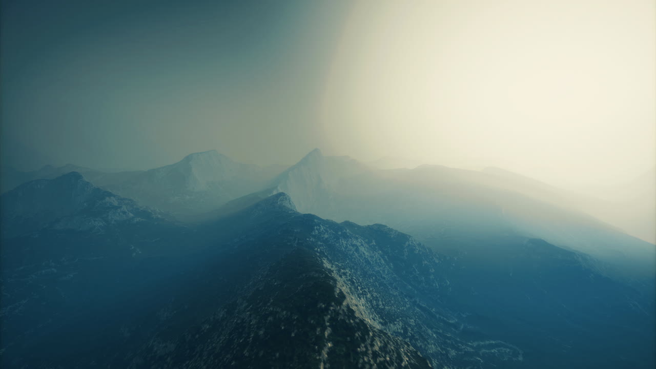 Majestic mountain landscape under a hazy sky at dawn