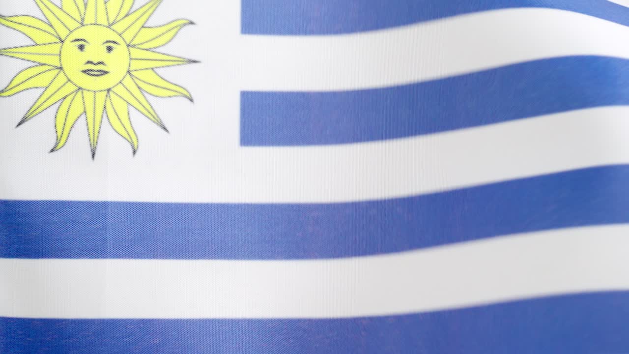 Uruguayan national flag waving by the wind