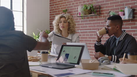 young-mixed-race-business-woman-using-tablet-computer-sharing-creative-ideas-presenting-project-showing-colleagues-in-office-meeting-diverse-team-working-together-brainstorming-planning-strategy