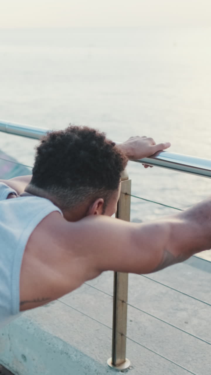 Man stretching by the ocean