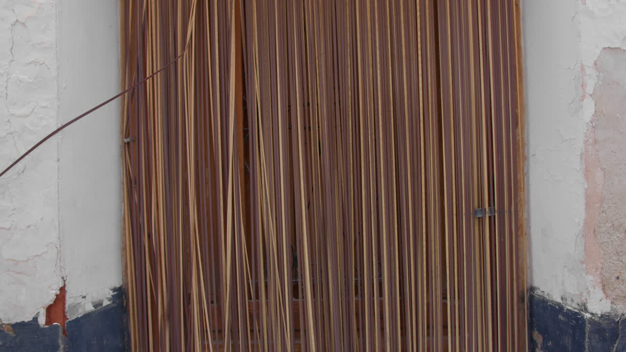 primer plano de una vieja puerta de madera con una cortina de caña