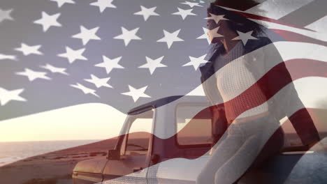 young biracial woman siting on a car with us flag waving foreground