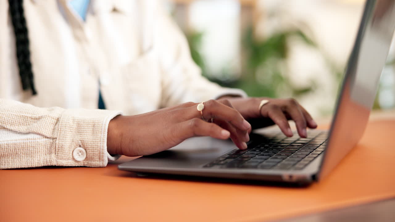 Close Up of Hands Typing on a Laptop Keyboard