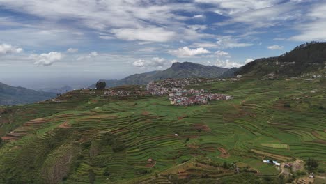 a peaceful hill station framed by dramatic cloud movement
