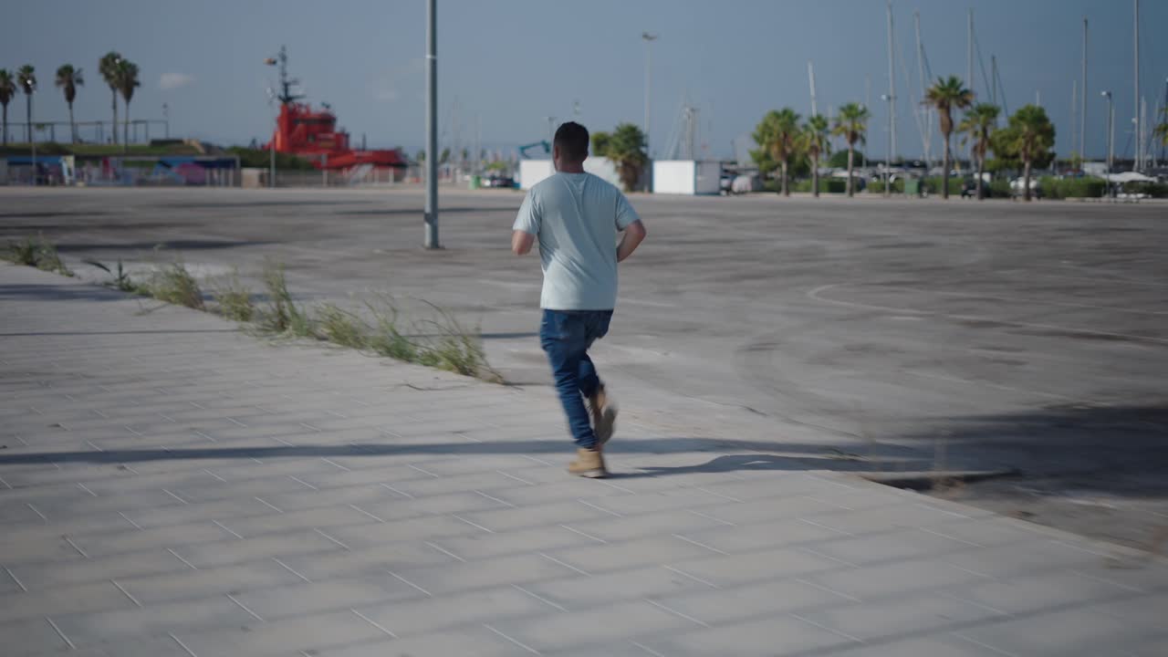 Man Running on Empty City Sidewalk